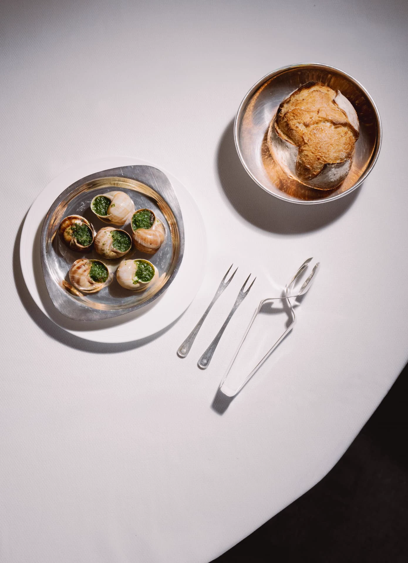 Escargots with herb butter and bread at Mazarine, French restaurant in Mayfair