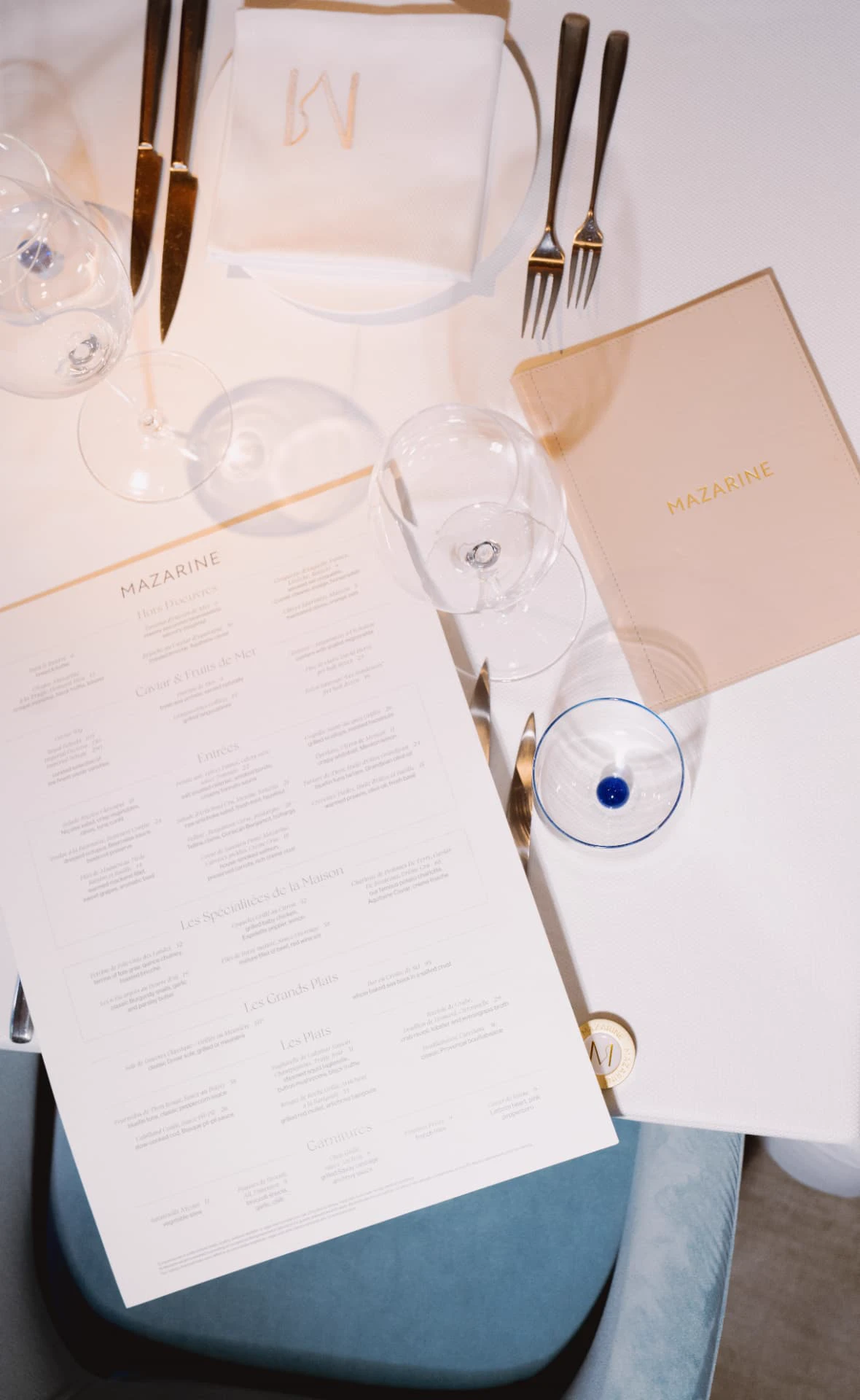 Mazarine table setting with leather menu, glassware and embroidered napkin in Mayfair